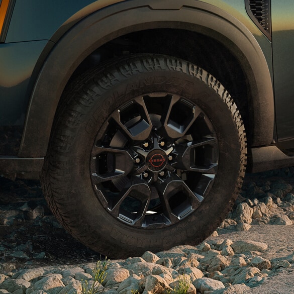 Close-up of 2026 Nissan Armada wheel on rocky ground